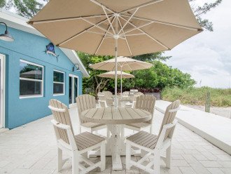High quality outdoor furniture with tables, chairs, & umbrellas.