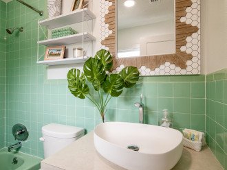 Bathroom has restored 1960's vintage green tiles