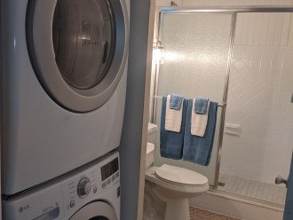 Full size washer and dryer next to second bathroom