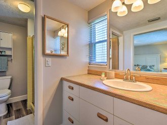Master Bath sink area has plenty of storage and comes equipped with hair dryer.