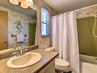 Guest bathroom has tub/shower combo and equipped with hair dryer.