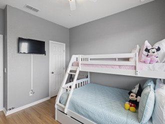 Designed for fun and rest, this bedroom is a cozy corner for kids and guests alike, with comforts that cater to a good night's sleep.
