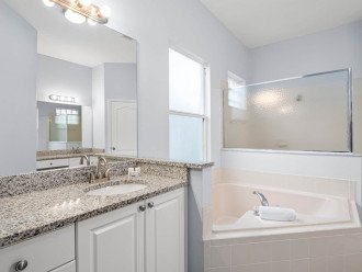 Bathroom with large bath and separate shower