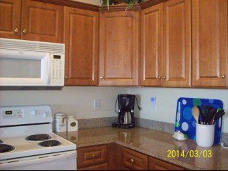 Kitchen with microwave, stove, coffee maker and lots of utensils