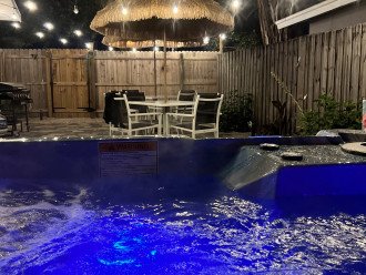 Relax in the hot tub under the patio lights