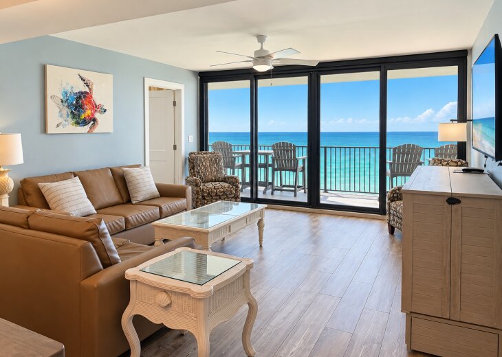 Open living and dining area with stunning Gulf views and balcony access.