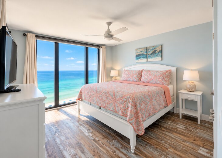 King bedroom with floor-to-ceiling Gulf views and direct balcony access.