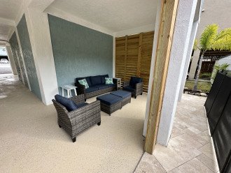 Sitting area under house, next to pool and dock