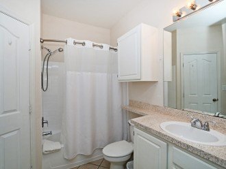 Master Bathroom with shower over bathtub, toilet & washbasin