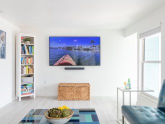 Watch your favorite shows on the wall-mounted smart HD TV & Sonos system