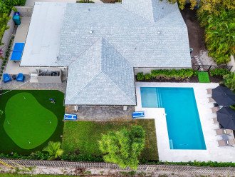 Take in the panoramic view of our home, where the backyard beckons with a pool, cornhole, putting green, and ping pong, promising endless fun in our Delray Beach hideaway.