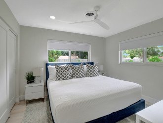 Bedroom 3, showcasing its inviting king-sized bed, ceiling fan, and pristine ambiance.