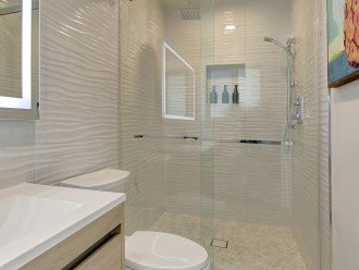 Enjoy the generous space and convenient amenities of our shower area, ensuring a rejuvenating experience.