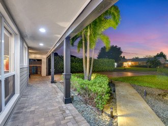 Welcome home: Step into our inviting covered entryway, seamlessly connecting the driveway to the comfort of our Delray Beach abode.