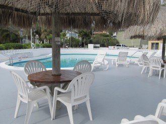 Solar Heated Swimming Pool with TiKI Umbrellas and lounge chairs