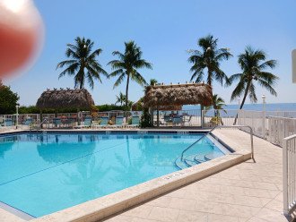 Large heated ocean side pool. Great for laps or lounging with 3 shaded tiki huts