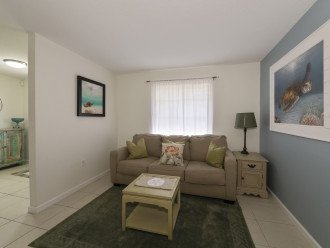 family room with pull out couch, next to foyer and living room