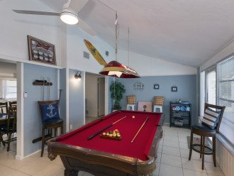 Florida room with billiards and cornhole boards