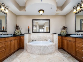 Jacuzzi Garden Tub is the centerpiece of this Glamourous Master Bath which also features His & Hers Sinks on opposing walls