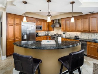 Stone Top Breakfast Bar separates the Kitchen from Dining Area