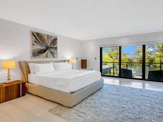 The primary bedroom with its balcony is overlooking the heated pool and the Mayan Lake.