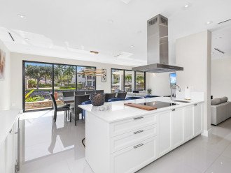 Chef's kitchen and dinning room with waterfront views of the waterway and the heated pool.