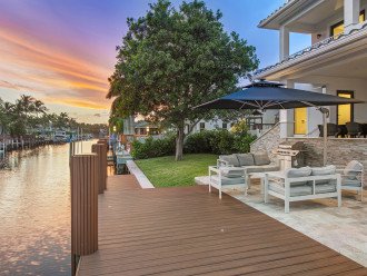 Waterfront tranquility from the backyard and its lounge areas, ideal for entertaining.