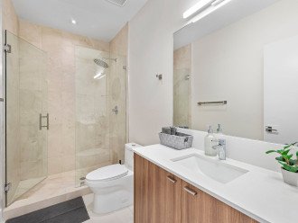 The ensuite bathroom features a walk-in shower with Fiji amenities and Comphy opulent towels.