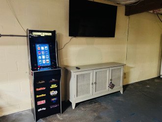 Arcade and 58" Smart TV in large garage