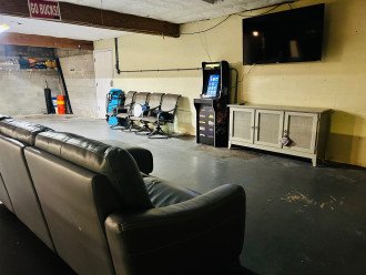 Arcade and 58" Smart TV in large garage