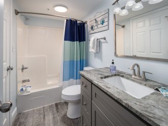 The guest bathroom has a shower/tub combo