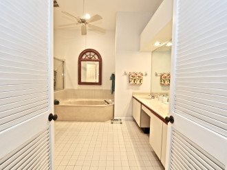 master bathroom with over shower, low-profi tub and double sink vanity