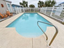 TROUT Steps to beach. Lovely two bedroom with screened porch and pool.
