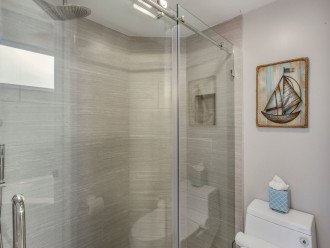 Master walk-in shower has a rain shower head and shower wand.