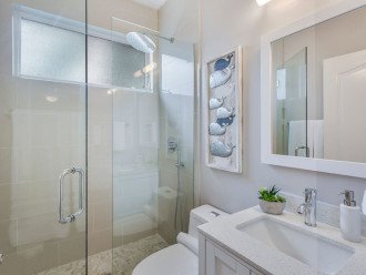 Newly renovated guest bathroom with quartz counter tops and rain shower