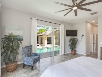master bedroom with 15' ceilings. view of pool.