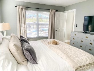 1st Primary Bedroom with pool views and king sized bed