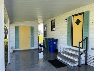 Front entry under covered carport and w&d in shed