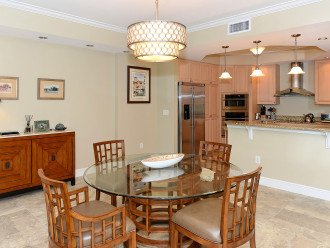 Great room dining area looking into fully equipped kitchen