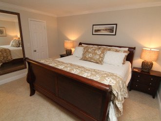 Master bedroom suite with walk in closet and TV.