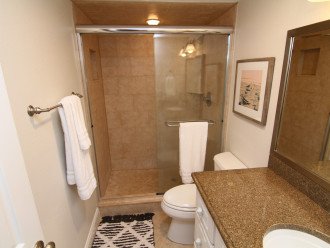 Guest bathroom updated with glass and tile shower.