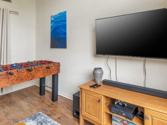 Game room with x-box, foosball, board games, and sofa bed
