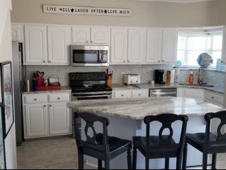 Kitchen with breakfast bar and granite counters