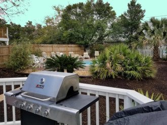 Dining patio with a gas grill and view of the pool.