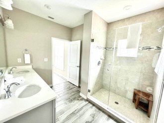 Tiled walk-in shower with granite countertops