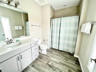 En-suite bathroom with shower and large mirror