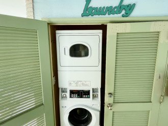 Stackable washer and dryer is located a few steps outside the front door