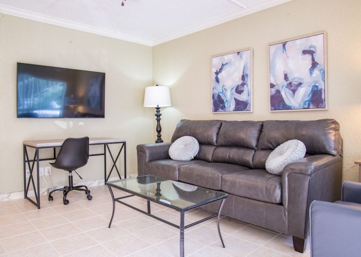 Enter the open space living room and relax on comfortable leather furniture including a recliner in front of the 55” smart TV.