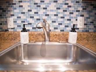 Kitchen sink includes a removable faucet, dish soap, hand soap and a sponge.