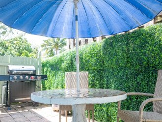 Shared west side yard includes BBQ grill and outdoor dining table and chairs